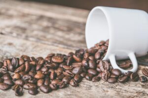 coffee beans falling out of a mug